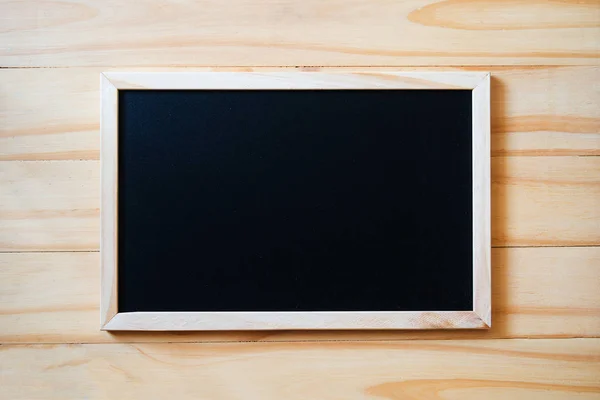 Blank  blackboard on wood background — Stock Photo, Image