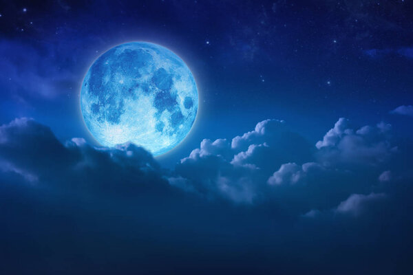 Full blue moon behind cloud over sky and star at night. Outdoors at night. Beautiful lunar shine moonlight over cloudy at nighttime with copy space background for headline text and graphic design. Elements of this image furnished by NASA