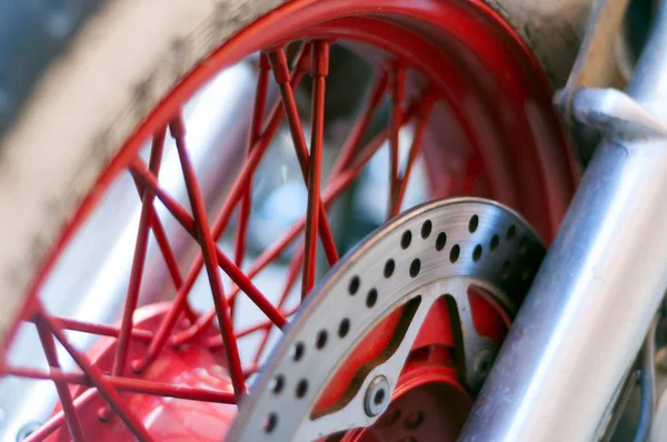 selective focus of a  motorbike disc break and wheel detail close up