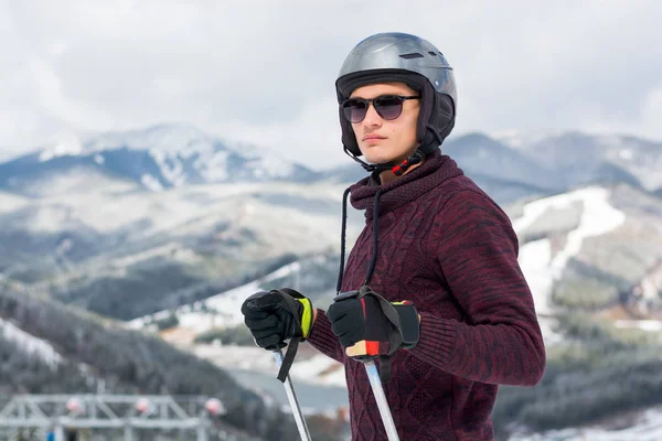 Skier in a glasses and a helmet in the mountains, a mountain lan