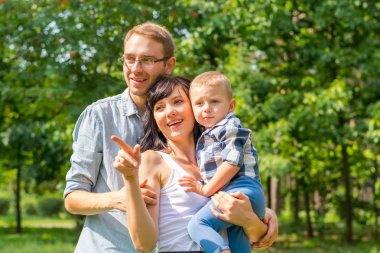 Aile parkta bir çocukla ilginç bir şeye benziyor. 