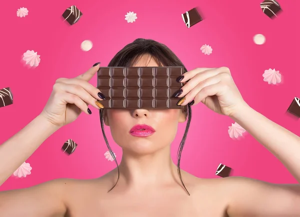 Woman and chocolate. Beautiful young woman covering her face wit — Stock Photo, Image