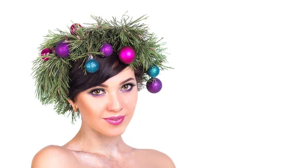 A beautiful woman in a wreath of Christmas tree branches and New — Stock Photo, Image