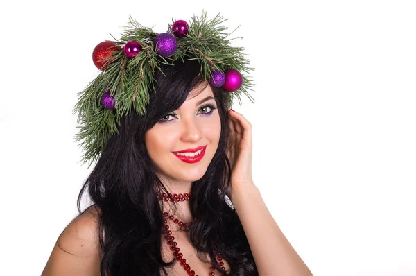 A beautiful woman in a wreath made from branches of a Christmas — Stock Photo, Image