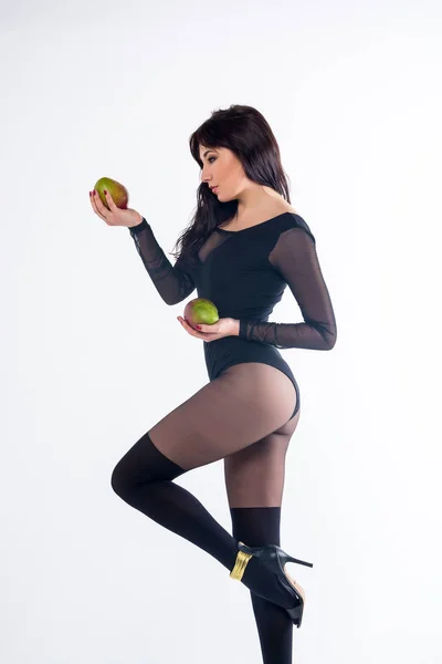 Slender girl in a black sexy lingerie with fruit mango on a whit — Stock Photo, Image