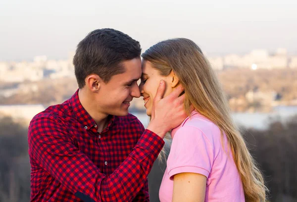 El chico va a besar a la joven en el fondo de la —  Fotos de Stock