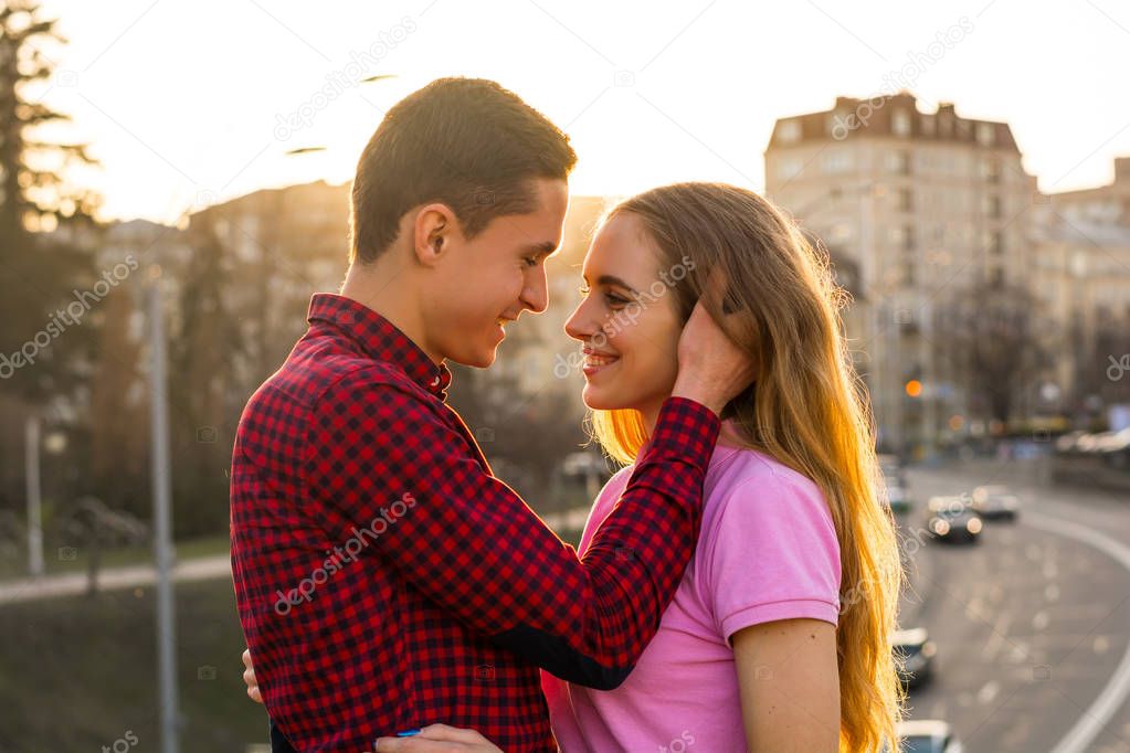 The man is going to kiss the young woman and touches her hair on