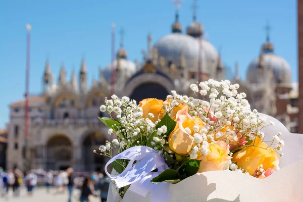 A bouquet of a roses at the Piazza San Marco background of Venic