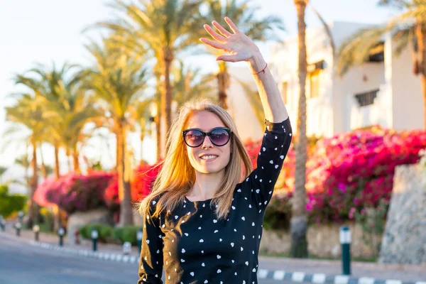 Joven Mujer Feliz Gafas Sol Ondea Mano Frente Florecientes Arbustos —  Fotos de Stock