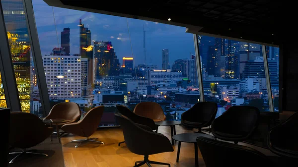 Bangkok city view point from Lounge interior. overlooking a magnificent cityscape blue sky and city in Thailand.