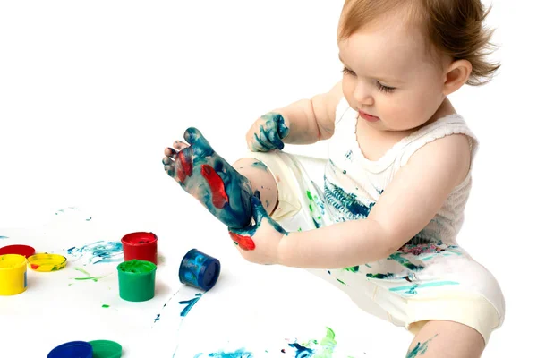 Ujj festék baba lábát és festékek edények Stock Kép