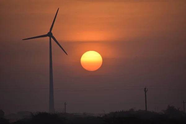 Windmill energy and the morning sunrise in city Dwarka