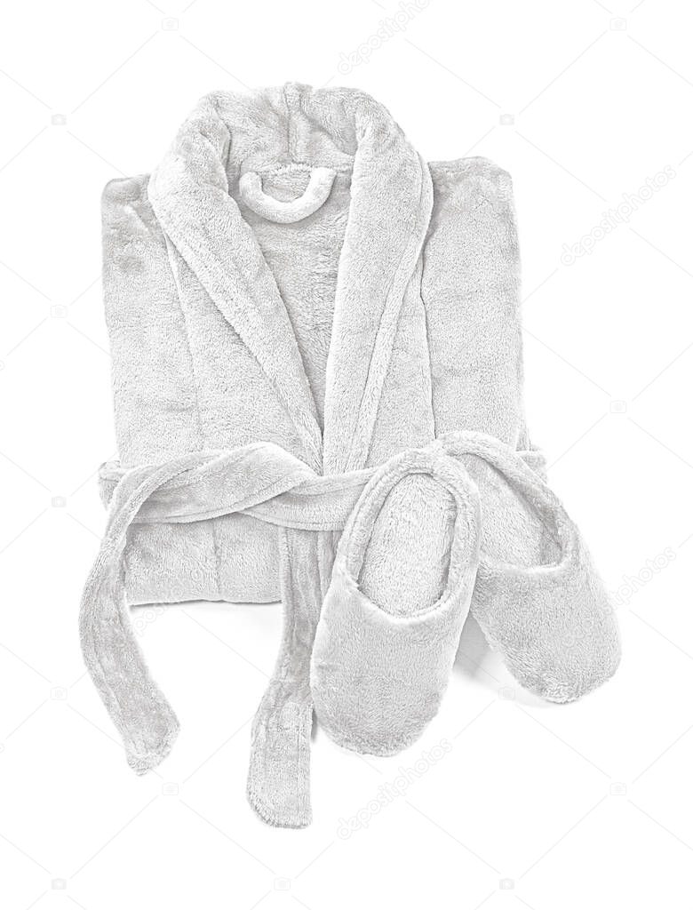 Folded bathrobe, and slippers isolated on white, top view.