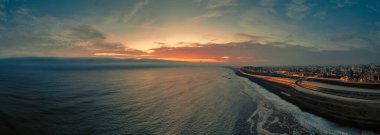 Panoramic night view of the Costa Verde trail at sunset, in San Miguel - Lima, Peru. clipart