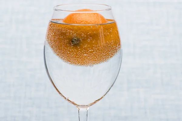 Orange in glass with water — Stock Photo, Image
