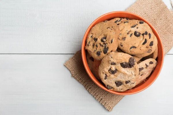 Chocolate chip cookies in orange bowl