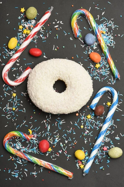 White coconut glazed donut on black background — Stock Photo, Image