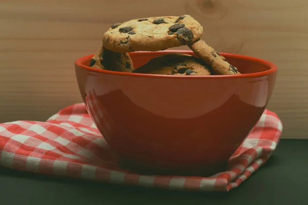 Chocolate chip cookies in red bowl