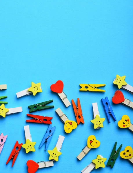 Colorful clothespins on blue — Stock Photo, Image