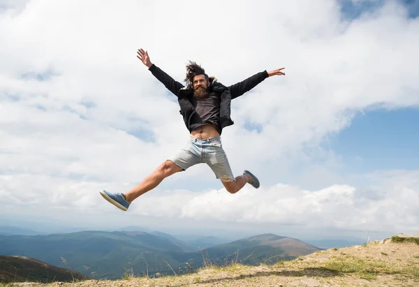 Homem hipster viajante com barba e bigode salta na montanha — Fotografia de Stock