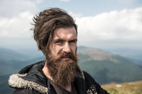 Man hipster traveler with beard and moustache portrait on mountain — Stock Photo, Image