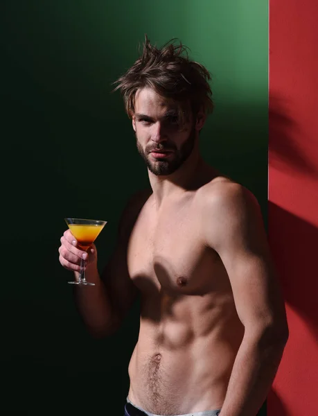 handsome muscular man with cocktail