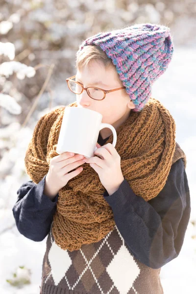 small boy with cup in winter outdoor