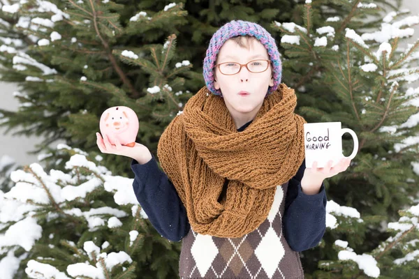 Kisfiú kupával és pénzes doboz télen szabadban — Stock Fotó