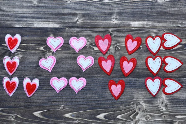 Amor de corazón de fieltro colorido en madera como decoración de día de San Valentín —  Fotos de Stock