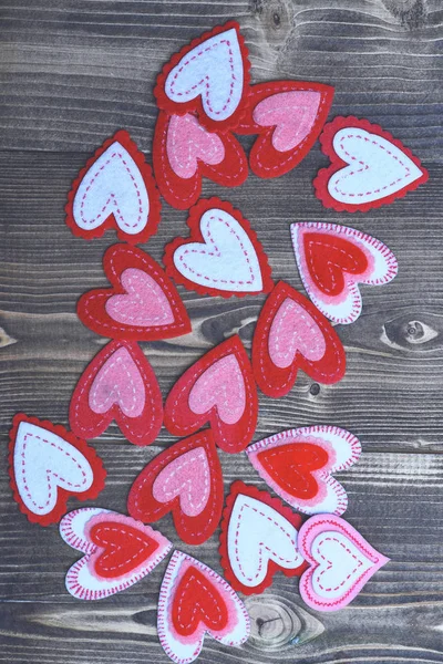 Colorful felt heart on wood as valentines day decoration — Stock Photo, Image