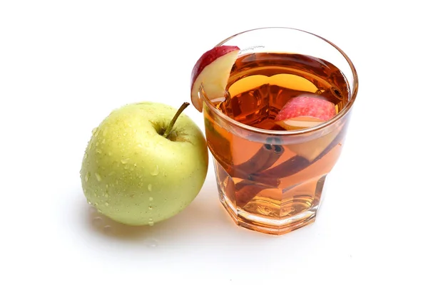 apple tea or mulled wine with cinnamon isolated on white