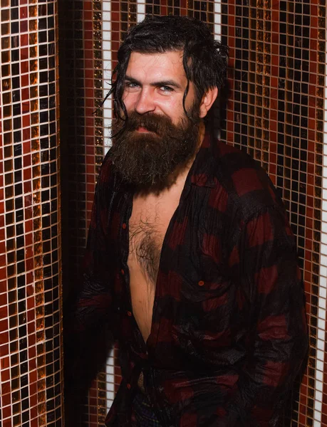 Handsome man washes in shower