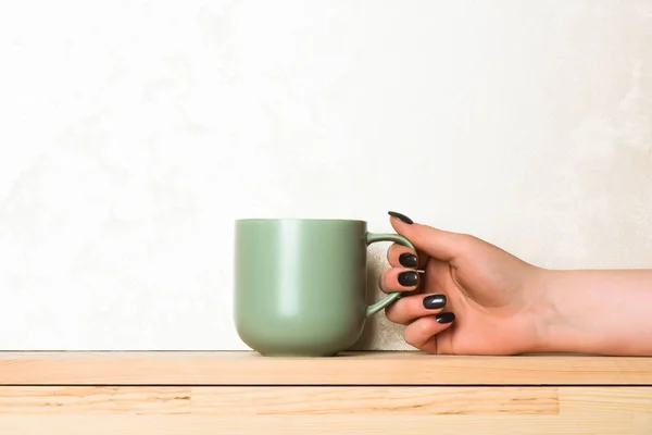 Green tea or coffee cup in hand on white background — Stock Photo, Image