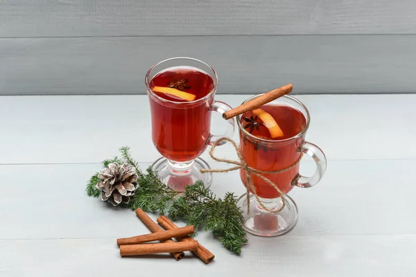 Tea or mulled wine with cinnamon, fir, pinecone at christmas — Stock Photo, Image