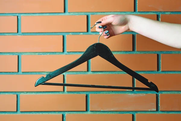 Пластикова вішалка моди в жіночій руці в гардеробі — стокове фото