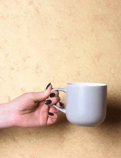 stock image blue tea or coffee cup in hand on textured background