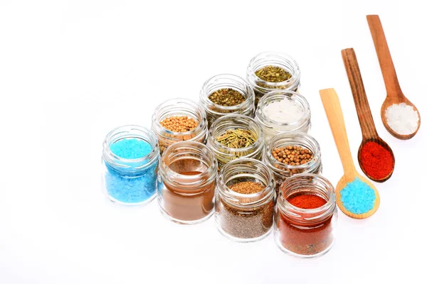 Various spices in spoons and jars on white background — Stock Photo, Image