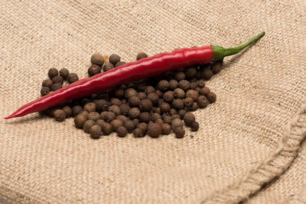 chili pepper with black pepper on sackcloth napkin