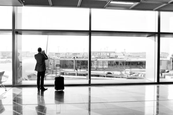 Άνθρωπος με αποσκευές αίθουσα αναμονής του αεροδρομίου στο τζάμι — Φωτογραφία Αρχείου