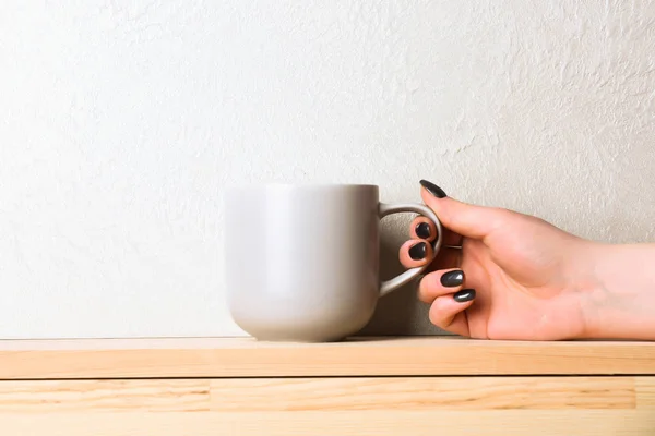 violet tea or coffee cup in hand on white background