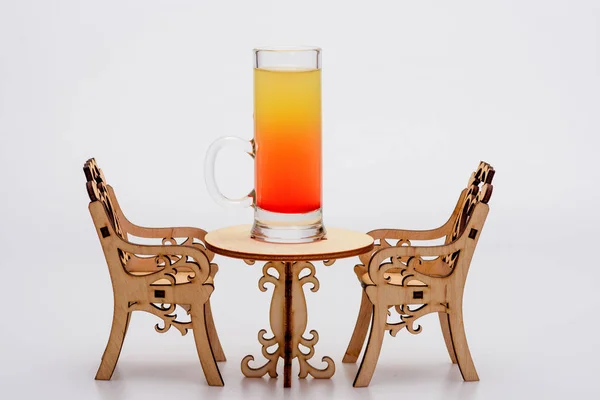 Alcohol cocktail in glass on little decorative table with chairs — Stock Photo, Image