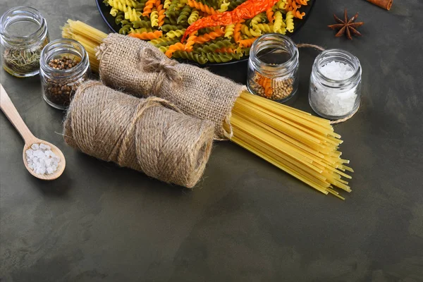 Bunch of spaghetti pasta and fusilli with string bobbin — Stock Photo, Image