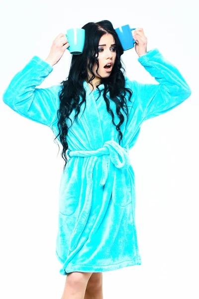 Sexy surprised girl posing in turquoise velour bathrobe with cup — Stock Photo, Image
