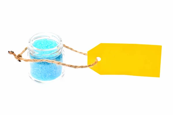 Sal azul en frasco de vidrio, etiqueta amarilla aislada en blanco — Foto de Stock