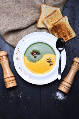 spinach and pumpkin cream soup with fried toast bread clipart