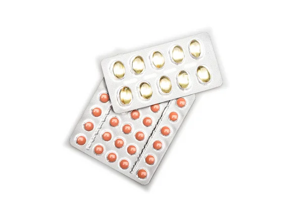 Red pills and capsules of cod-liver oil in blisters — Stock Photo, Image