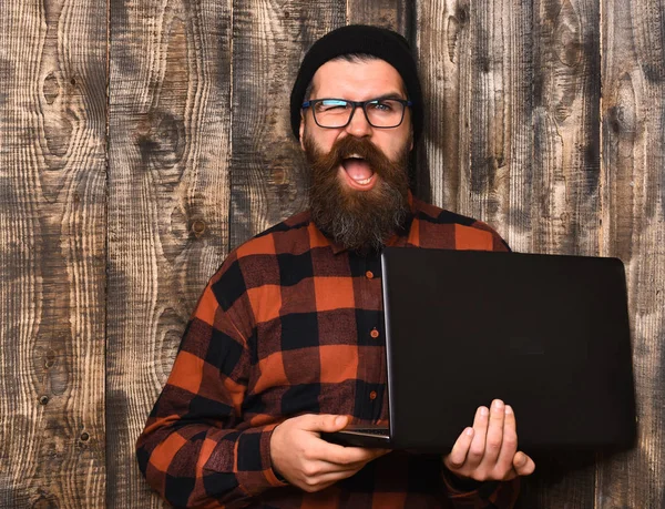 Skäggig brutal kaukasisk hipster som håller laptop — Stockfoto