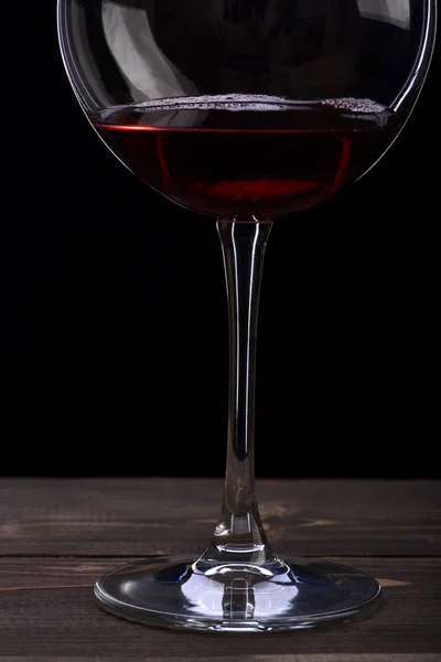 Wineglass with wine on black background — Stock Photo, Image