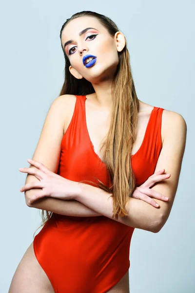 Pretty girl with sexi blue lips in red bodysuit — Stock Photo, Image