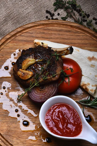 fried rib meat, pita bread, tomato, onion, garlic, ketchup, thyme